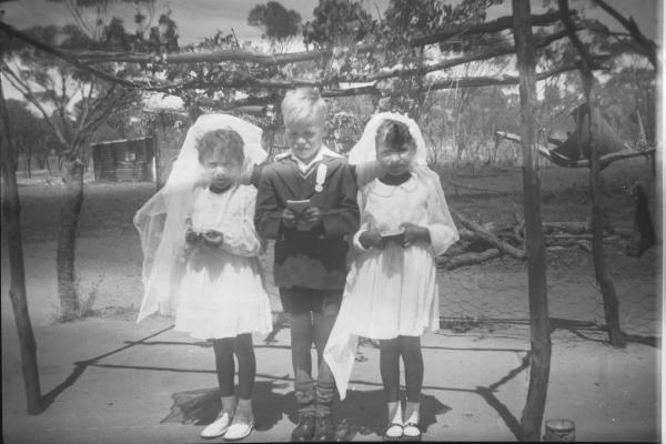  L-R Lois Phillips Kevin Walley and Norma Walley dressed for their first Holy Communion Goomalling ca1956