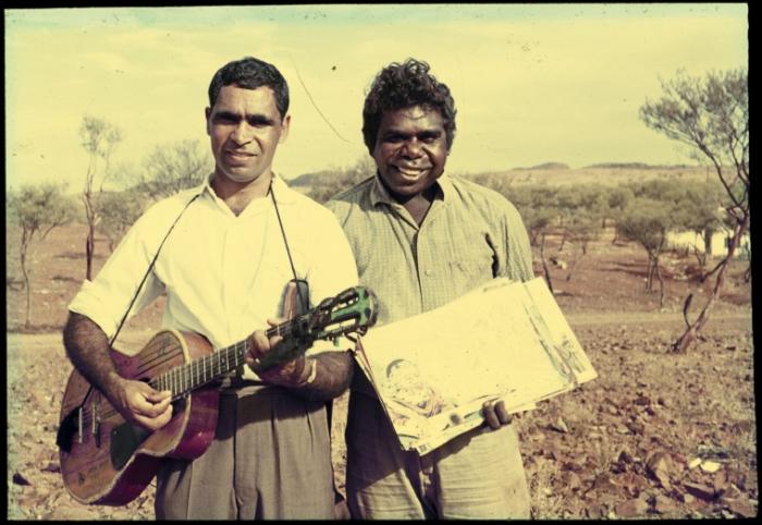Ron Williams holding a guitar with another Aboriginal man