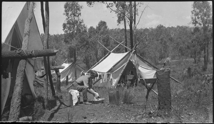 Dick Perry washing cloths at a Forest Department camp at Hay Creek near Mundaring Weir Western Australia ca 1921