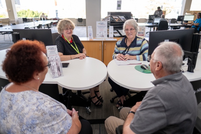 Volunteers and library visitors at Family History WA Desk