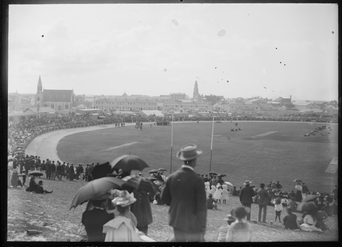 View of a crowd and the field at Fremantle Oval and surrounding buildings ca 1895