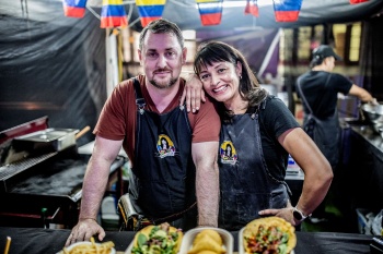 Matt and Marcela ODonohue Valencia standing beside food stall