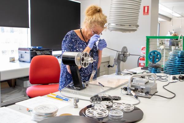 Staff member examining film in Conservation