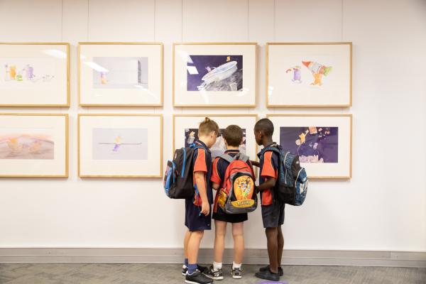 Primary School children look at an exhibition in the Story Place Gallery at the State Library of WA