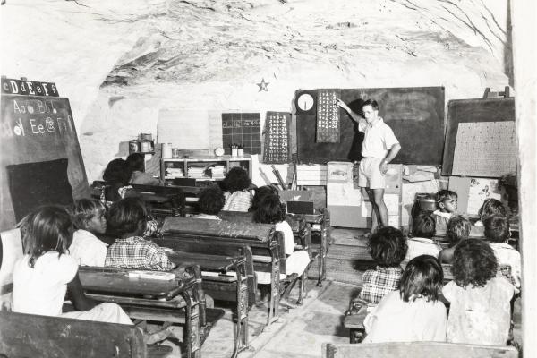 Cyril Burcham teaching children in caves at Gogo Station c1957