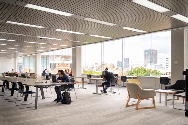 People at tables Level 3 State Library