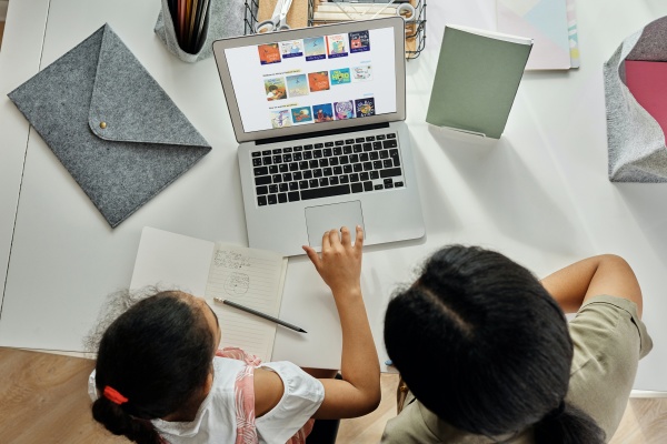 Child and parent looking at Kids Kanopy on laptop screen