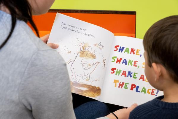 Child reading with his mum