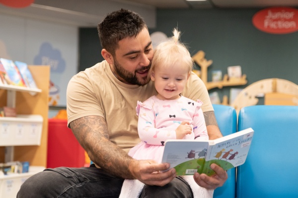 Father reading to daughter