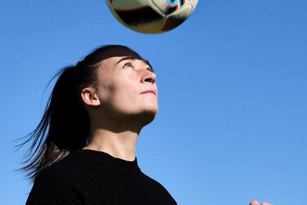 Mikayla Lyons bouncing a soccer ball on her head 