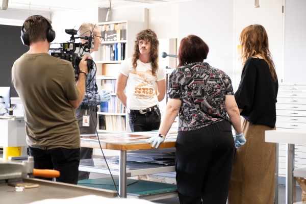 Dr Adam Trainer showing local rocker Cal Kramer newly acquired letters by Bon Scott in the Preservation Lab 2023