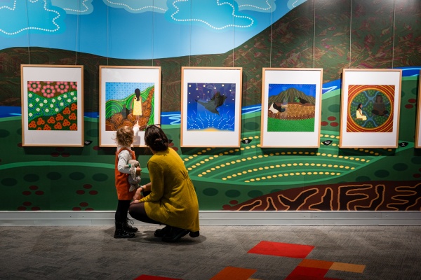 Mother and child looking at the Crow Baby Exhibition
