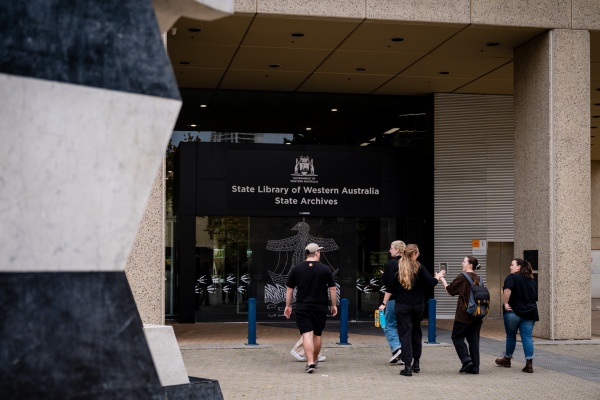 group of people walking into the State Library