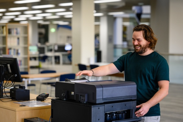 Person using photocopier at the State Library
