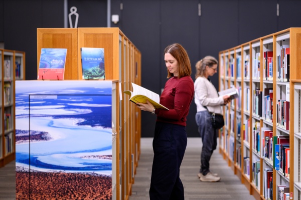 Looking at books on Level 3 of the State Library