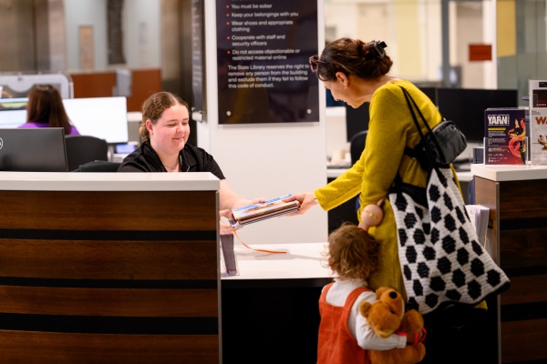 Mother and child borrowing books