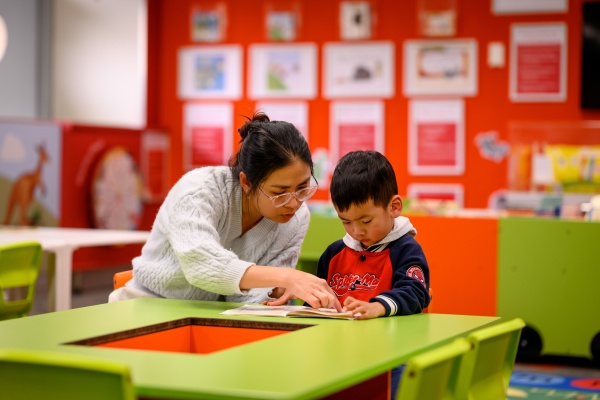 Parent and child reading at The Story Place