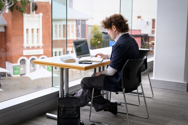 Student on laptop near window