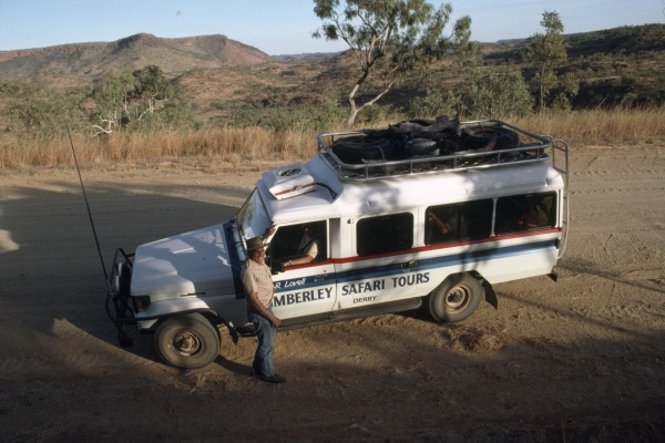 Sam Lovell standing beside his tour vehicle in the Kimberley c1987