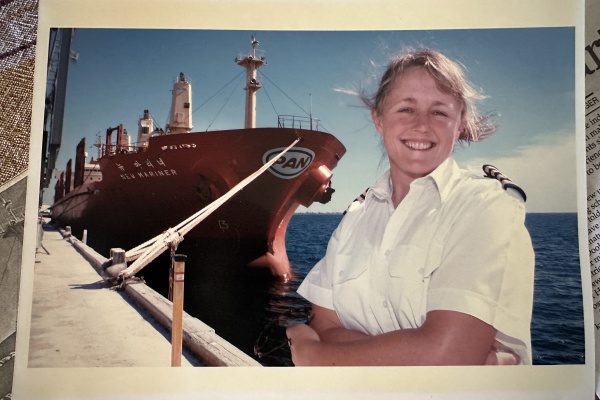 female captain in front of ship