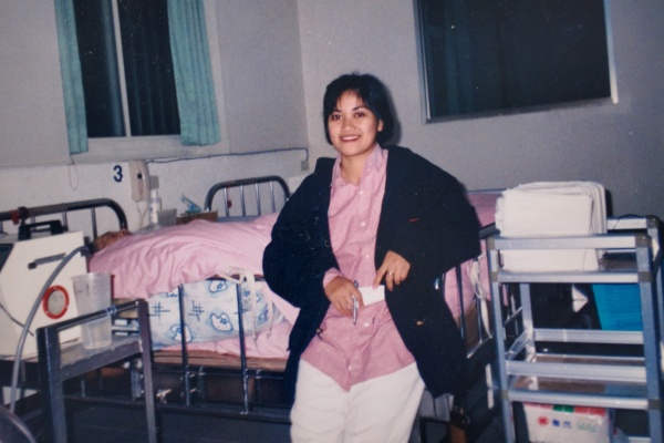 nurse sitting on hospital bed
