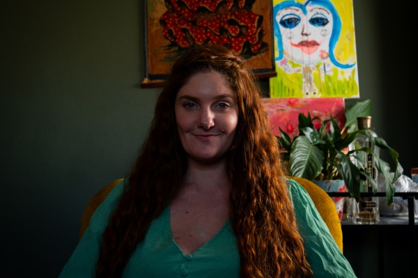 portrait of woman with red hair an wearing a green dress