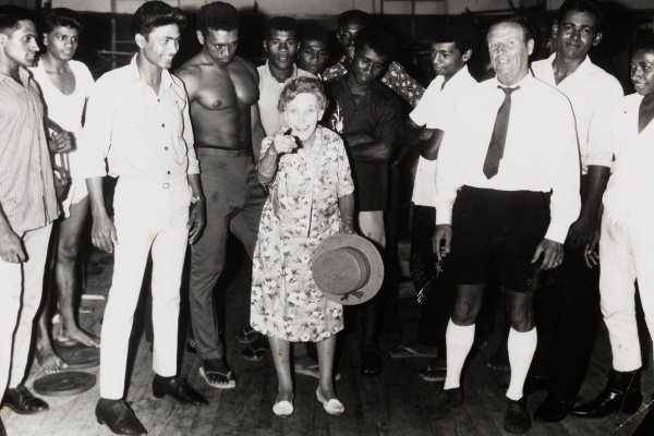 Effie Fellows in a gymnasium in Suva Fiji surrounded by young boxers and onlookers 1968