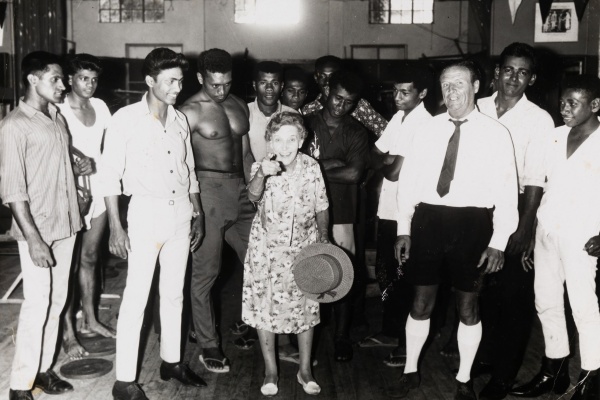 Effie Fellows in a gymnasium in Suva Fiji surrounded by young boxers and onlookers 1968