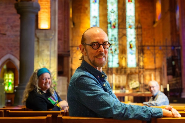 three people sitting in a church