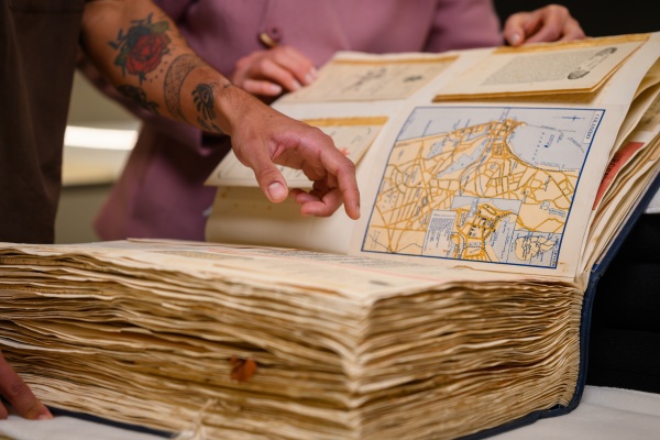 Looking at a book in the Leah Jane Cohen Reading Room 