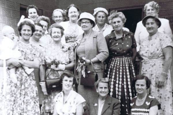 Yearling CWA members and friends in front of new building 1955