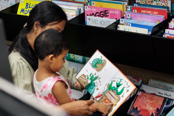 Mother and child looking at  book at the Ruth Faulkner Library in Belmont 2026