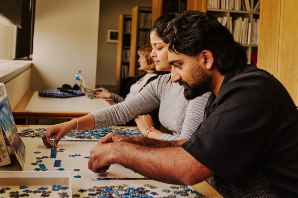 People playing with Jigsaw Puzzles
