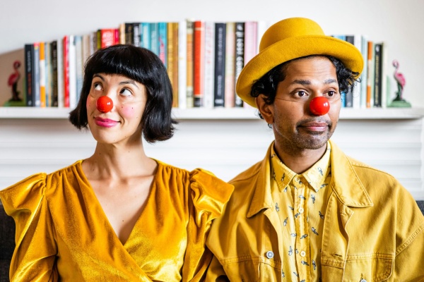 two dressed in yellow with red clown noses