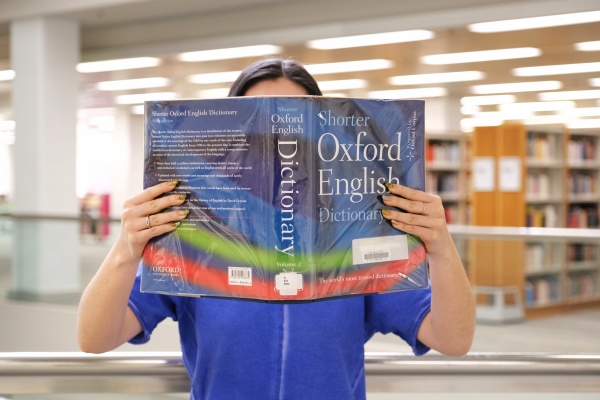Woman reading Shorter Oxford English Dictionary