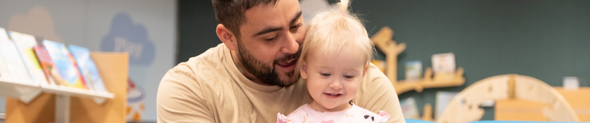 Father reading to daughter