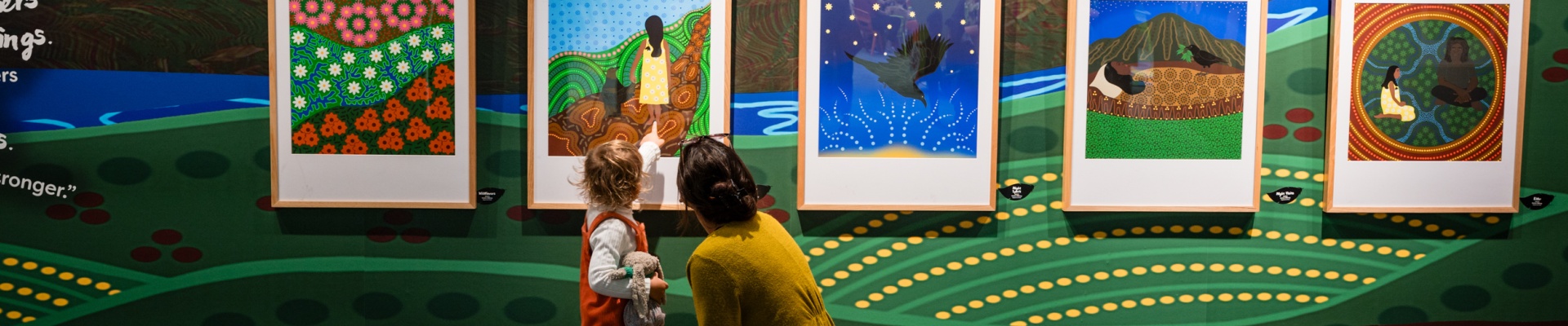 Mother and child looking at the Crow Baby Exhibition