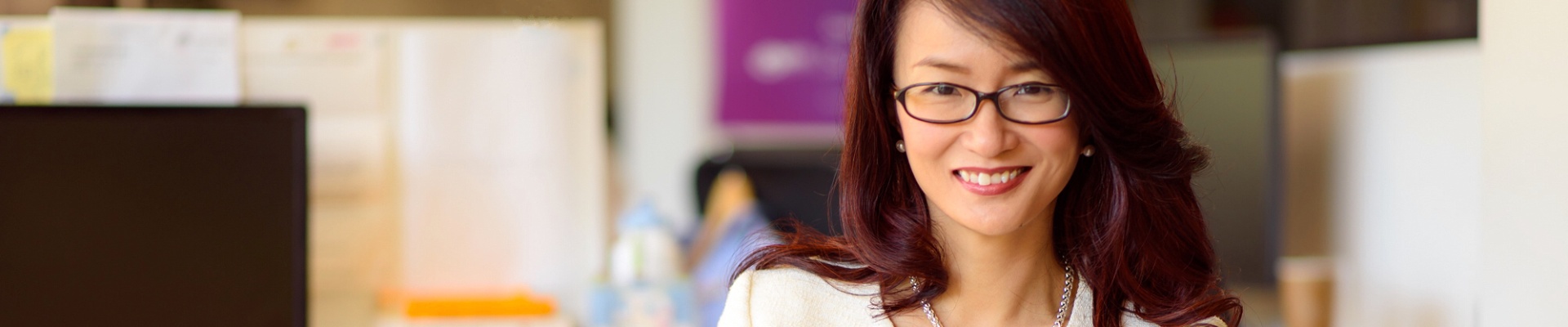 portrait of Dr Sandy Chong sitting on sofa