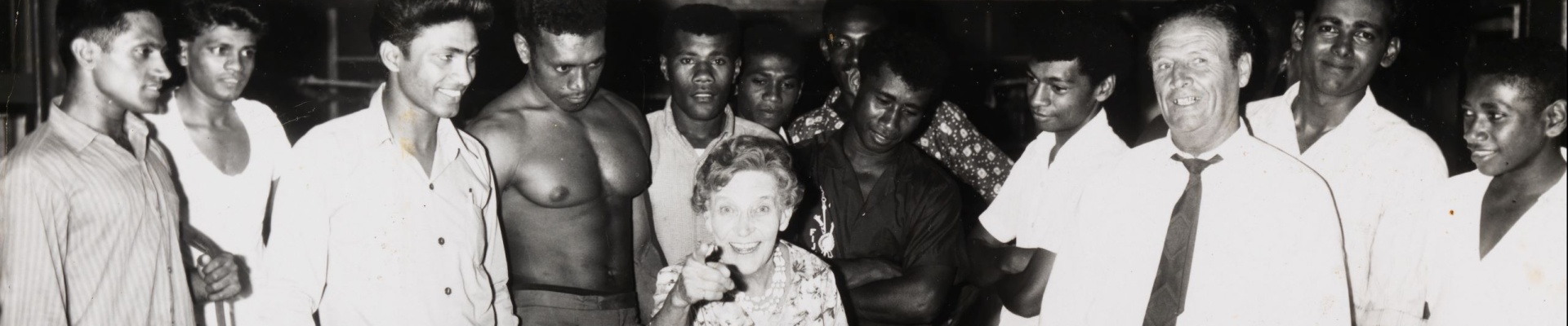 Effie Fellows in a gymnasium in Suva Fiji surrounded by young boxers and onlookers 1968