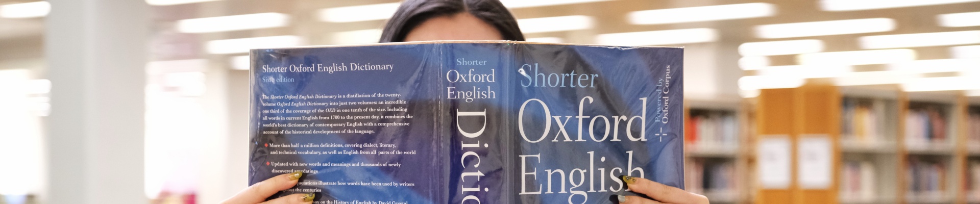 Woman reading Shorter Oxford English Dictionary