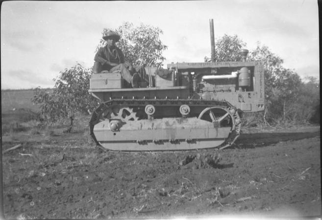 Cecil Phillips on a caterpillar tractor near the oil mallees at Goomalling ca1950