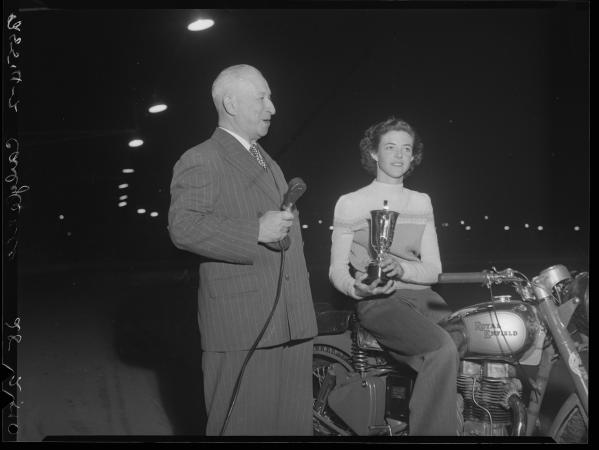 Carl Cohen presents Winifred Wells a silver trophy from the Enfield Cycle Co Ltd England at the Claremont Speedway 1951