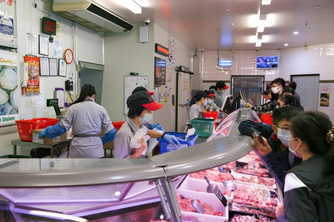 Customers and staff wear masks at Wing Hong Butchers in William Street Perth 19 March 2020