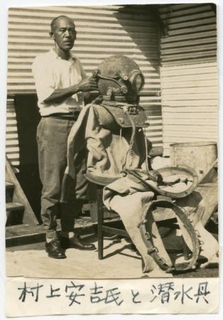 Japanese man with an old diving suit propped up on a chair