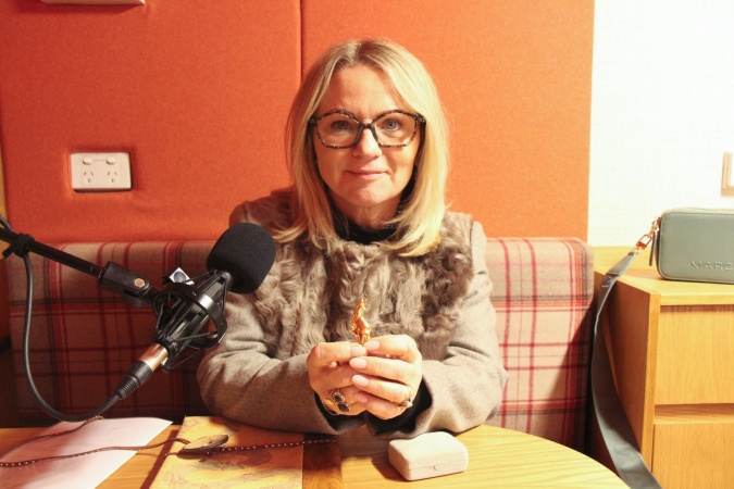Cheryl Burton holding tiny gold kangaroo