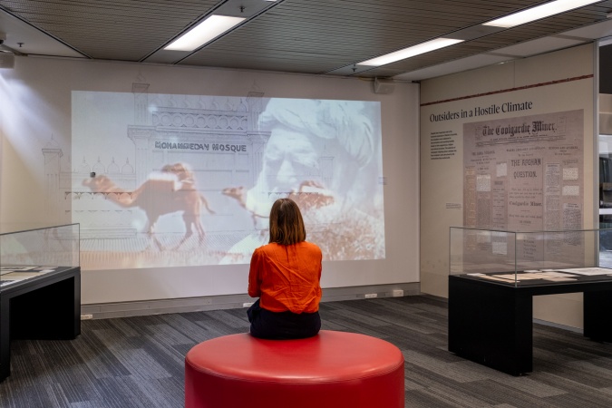 Watching a video inside the Sheiks Fakes and Cameleers exhibition 2024