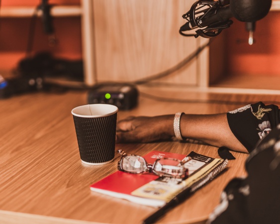 Inside The Chin Wagon with hand next to cup of coffee