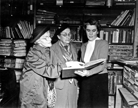 Mollie Lukis views records of the Edith Cowan Memorial Committee with committee members Sarah May Monaghan and Harriet Ann Monaghan September 1952