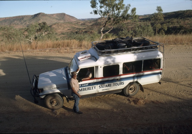 Sam Lovell standing beside his tour vehicle in the Kimberley c1987