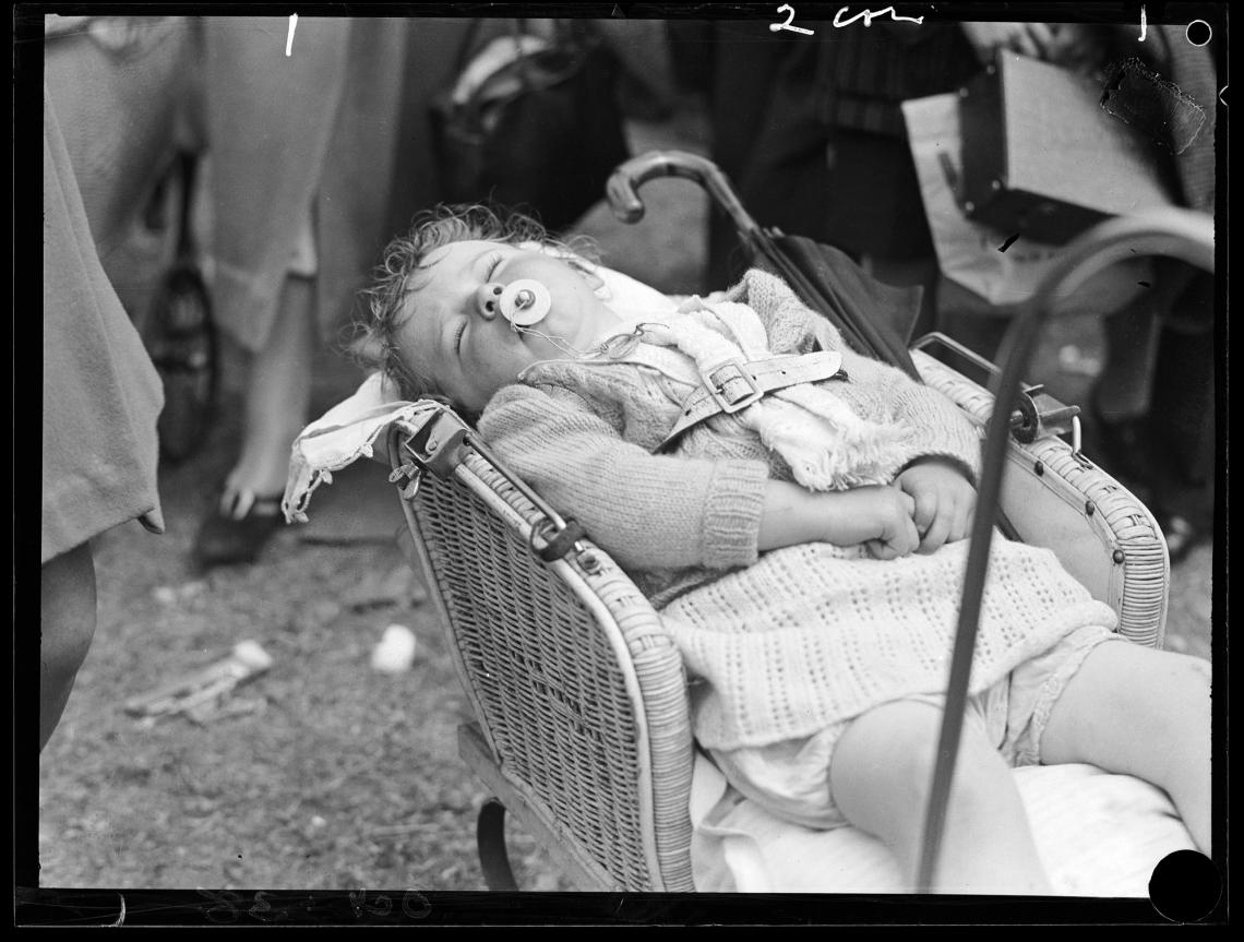 Young girl asleep in pram at the Royal Show 1938